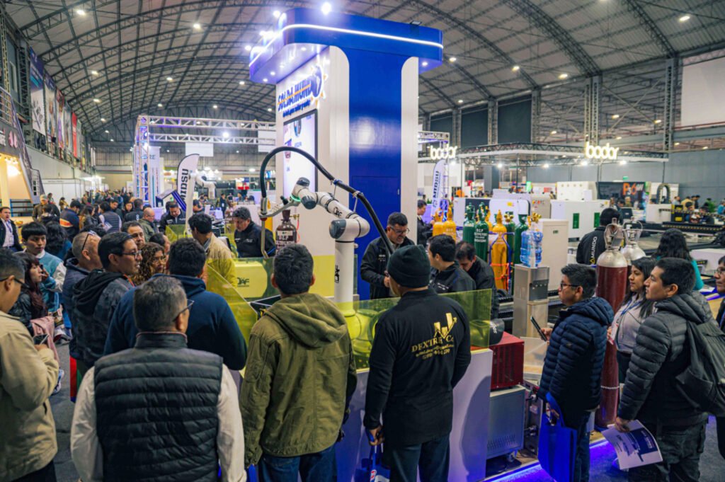 Visitantes en un stand de soldadura y robótica durante FIMM en el pabellón del Jockey